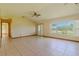 Bright living room featuring tile floors, ceiling fan, and lots of natural light at 6773 Se 87Th St, Ocala, FL 34472