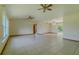 Bright living room with tile flooring, neutral walls, and multiple ceiling fans at 6773 Se 87Th St, Ocala, FL 34472