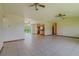 Open-concept living space with tile floors, ceiling fans, seamlessly connects to the kitchen at 6773 Se 87Th St, Ocala, FL 34472