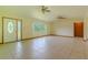 Inviting living area featuring a large window, tile flooring, and a front door entrance at 6773 Se 87Th St, Ocala, FL 34472