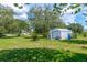 Large shed with roll up door, next to propane tank and grassy yard at 6773 Se 87Th St, Ocala, FL 34472