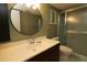 Bathroom featuring a dark wood vanity cabinet, white countertop, and shower with sliding glass doors at 8655 Sw 98Th Street Rd # G, Ocala, FL 34481