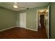 Bedroom with a ceiling fan, wood floors, and a closet with bi-fold doors at 8655 Sw 98Th Street Rd # G, Ocala, FL 34481