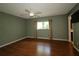Bedroom features a ceiling fan, wood floors, and a large window at 8655 Sw 98Th Street Rd # G, Ocala, FL 34481
