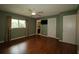 Bedroom with a ceiling fan, wood floors, a window, and a view to the bathroom at 8655 Sw 98Th Street Rd # G, Ocala, FL 34481