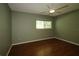 Bedroom featuring a ceiling fan, hardwood floors, and a window at 8655 Sw 98Th Street Rd # G, Ocala, FL 34481