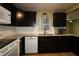 The kitchen features granite countertops, white appliances, dark cabinetry, and modern backsplash at 8655 Sw 98Th Street Rd # G, Ocala, FL 34481