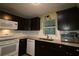 Modern kitchen with stainless appliances, granite countertops, dark cabinetry and ample natural light at 8655 Sw 98Th Street Rd # G, Ocala, FL 34481