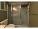 Close up of a stand-up shower with sliding glass doors and blue and grey tile floor at 8655 Sw 98Th Street Rd # G, Ocala, FL 34481