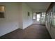Enclosed sunroom with carpet and multiple windows offering natural light at 8655 Sw 98Th Street Rd # G, Ocala, FL 34481
