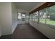 Sunroom with carpet and multiple windows overlooking a well-maintained backyard at 8655 Sw 98Th Street Rd # G, Ocala, FL 34481