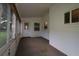Enclosed sunroom with carpet, white walls, and windows for natural light at 8655 Sw 98Th Street Rd # G, Ocala, FL 34481