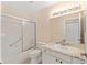 Bathroom featuring a shower with glass sliding doors, a white toilet, and vanity with granite countertop at 8689 Se 141St Street Rd, Summerfield, FL 34491