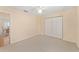 Bedroom featuring neutral walls and carpet, a ceiling fan, and a double door closet at 8689 Se 141St Street Rd, Summerfield, FL 34491