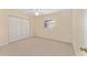 Bedroom featuring neutral walls and carpet, a ceiling fan, and a double door closet at 8689 Se 141St Street Rd, Summerfield, FL 34491