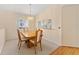 Dining area with a wooden table and chairs, under a chandelier, connected to the kitchen at 8689 Se 141St Street Rd, Summerfield, FL 34491