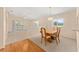 Cozy dining area with a wooden table set, carpeted floor, and a view to a sunroom at 8689 Se 141St Street Rd, Summerfield, FL 34491
