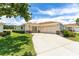 Charming home featuring a two-car garage and a well-manicured lawn at 8689 Se 141St Street Rd, Summerfield, FL 34491