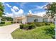 Charming single-story home with a well-manicured lawn featuring mature landscaping and brick accents at 8689 Se 141St Street Rd, Summerfield, FL 34491