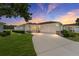 Charming single-story home with a well-manicured lawn and a spacious driveway at 8689 Se 141St Street Rd, Summerfield, FL 34491