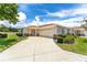 Charming single-story home with a well-manicured lawn and a spacious driveway at 8689 Se 141St Street Rd, Summerfield, FL 34491