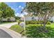 View of a well-maintained home exterior featuring landscaped grounds, a mailbox, and mature trees at 8689 Se 141St Street Rd, Summerfield, FL 34491
