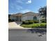 Charming single story home with well-manicured landscaping, a two-car garage, and a concrete driveway at 8689 Se 141St Street Rd, Summerfield, FL 34491