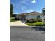 Charming single story home with well-manicured landscaping, a two-car garage, and a concrete driveway at 8689 Se 141St Street Rd, Summerfield, FL 34491