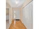 Entryway featuring tile and wood floors, a closet, and an archway to another room at 8689 Se 141St Street Rd, Summerfield, FL 34491