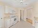 Bright kitchen features white appliances, tile flooring, and a seamless flow to the rest of the home at 8689 Se 141St Street Rd, Summerfield, FL 34491