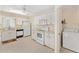 Bright kitchen with white appliances, countertop, and easy access to laundry room at 8689 Se 141St Street Rd, Summerfield, FL 34491