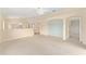 Open living room with neutral carpet, an open floor plan, and seamless transitions to adjacent rooms at 8689 Se 141St Street Rd, Summerfield, FL 34491