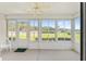 Enclosed sunroom featuring white walls and trim and a view of the backyard at 8689 Se 141St Street Rd, Summerfield, FL 34491
