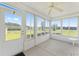 Enclosed sunroom featuring white walls and trim and a view of the backyard at 8689 Se 141St Street Rd, Summerfield, FL 34491