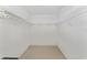 Empty walk-in closet with wire shelving on three sides and neutral carpeting at 8689 Se 141St Street Rd, Summerfield, FL 34491