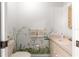 Charming bathroom features floral accents, a vanity with storage, and a neutral color palette at 8830 Sw 98Th Pl # M, Ocala, FL 34481