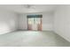 Spacious primary bedroom featuring a ceiling fan and large window with floral curtains at 8830 Sw 98Th Pl # M, Ocala, FL 34481