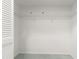 Empty closet with a wire shelf and neutral carpeting, perfect for organizing belongings at 8830 Sw 98Th Pl # M, Ocala, FL 34481