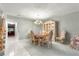 Bright dining room featuring a chandelier, elegant furniture, and an adjoining staircase at 8830 Sw 98Th Pl # M, Ocala, FL 34481