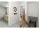 Hallway with staircase, ornate mirror, and access to bathroom, connecting different areas of the home at 8830 Sw 98Th Pl # M, Ocala, FL 34481