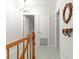 Second-floor hallway with wooden banister and decorative wall mirror at 8830 Sw 98Th Pl # M, Ocala, FL 34481