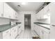 Kitchen featuring white cabinetry, a tiled floor, and ample counter space at 8830 Sw 98Th Pl # M, Ocala, FL 34481