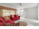 Cozy living room featuring tile flooring, comfortable sofa, and natural light at 8830 Sw 98Th Pl # M, Ocala, FL 34481