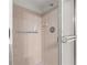 Updated shower featuring tile walls, showerhead, and glass door at 8830 Sw 98Th Pl # M, Ocala, FL 34481