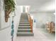 Inviting staircase with carpeted steps and wood railing, leading to the upper level of the home at 8830 Sw 98Th Pl # M, Ocala, FL 34481