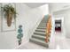 Bright stairway with carpet and a wood railing leading to the upper level at 8830 Sw 98Th Pl # M, Ocala, FL 34481