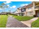 Picturesque street view showcasing charming townhouses and lush green landscaping at 8830 Sw 98Th Pl # M, Ocala, FL 34481