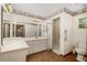 Bathroom with a large mirror, white cabinets, and a walk-in shower at 8959 Sw 96Th Ln # A, Ocala, FL 34481