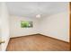 This bedroom features wood-look floors, a ceiling fan, base trim, and a window at 8959 Sw 96Th Ln # A, Ocala, FL 34481