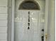 The address 8599A is displayed prominently on the glass pane of the front door at 8959 Sw 96Th Ln # A, Ocala, FL 34481